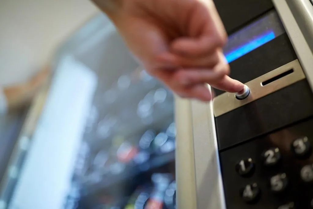 Person pressing button on a vending machine