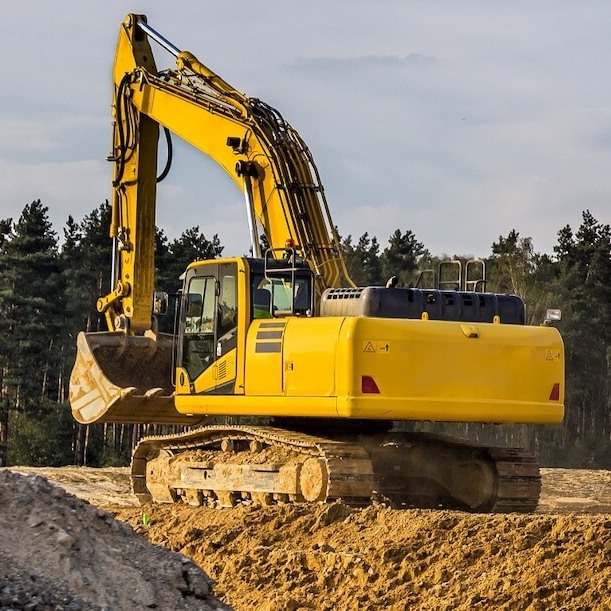 Yellow digger on site from the side